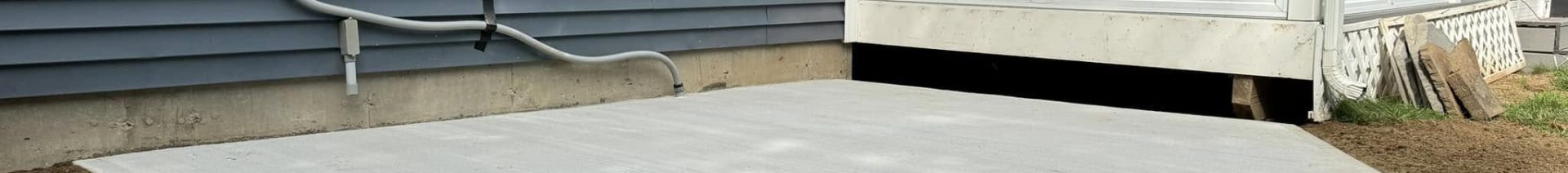 a fresh poured patio area in front of a house